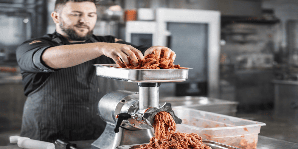 The Complete Guide to Commercial Meat Grinder Machines for Industrial & Food Processing Businesses (2026) 2 commercial meat grinder machine used in real food processing environment