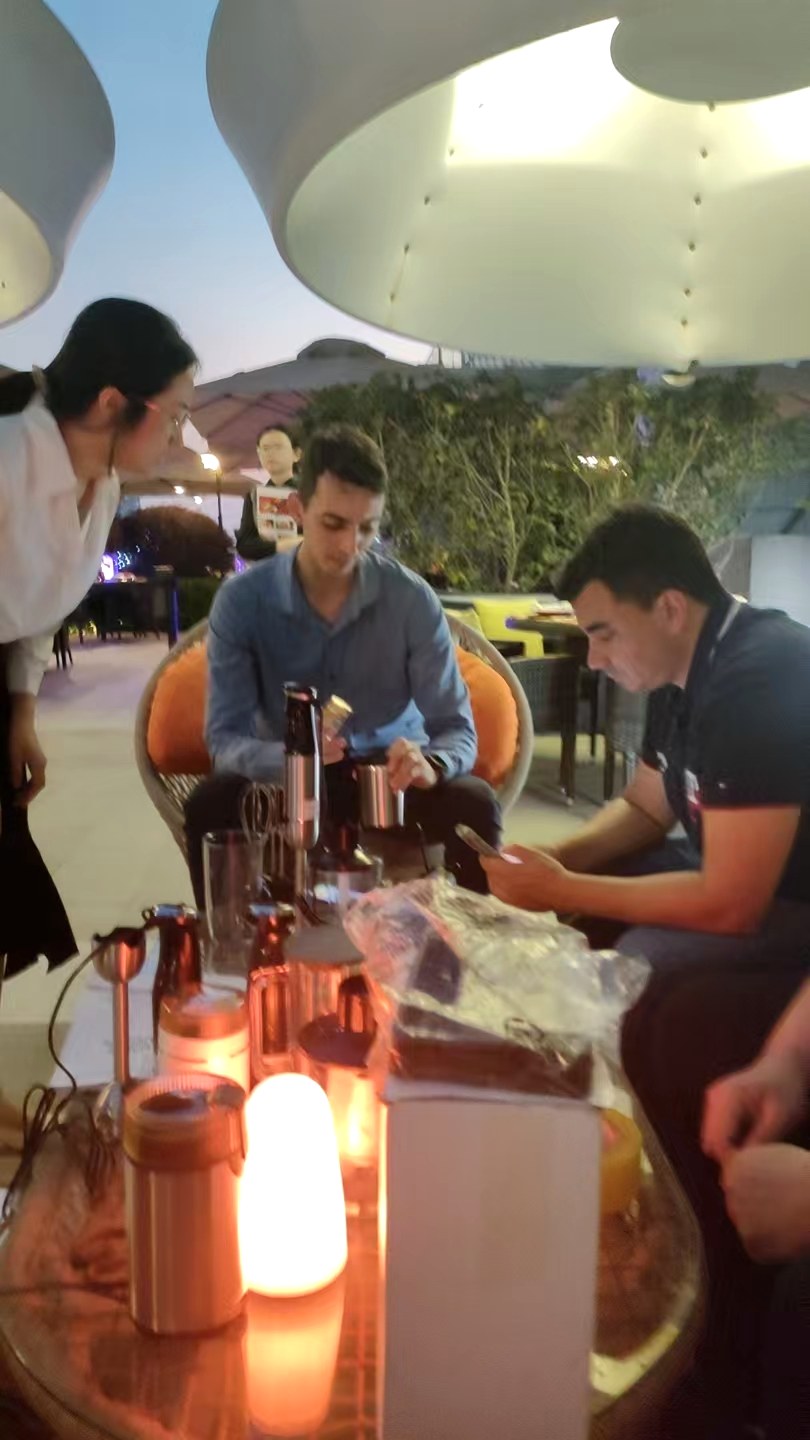 Buyer testing hand blenders at YLD Home factory visit